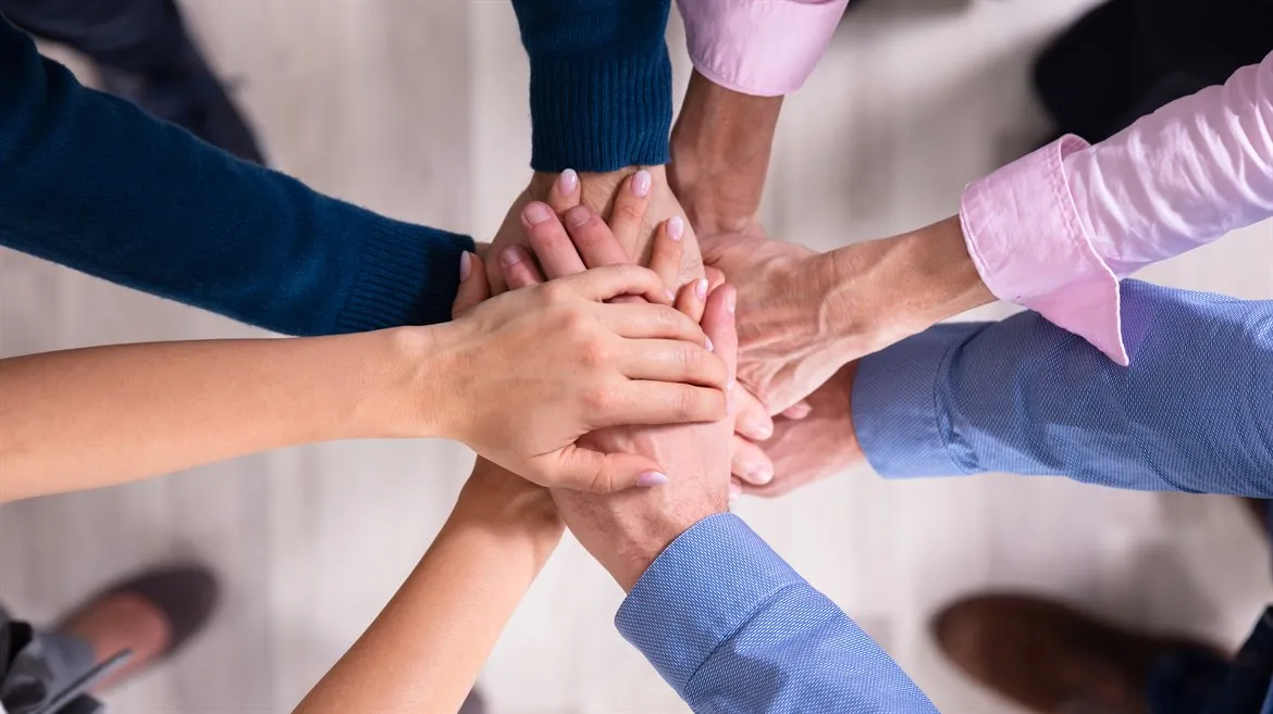 Businesspeople Stacking Hands Over Each Other