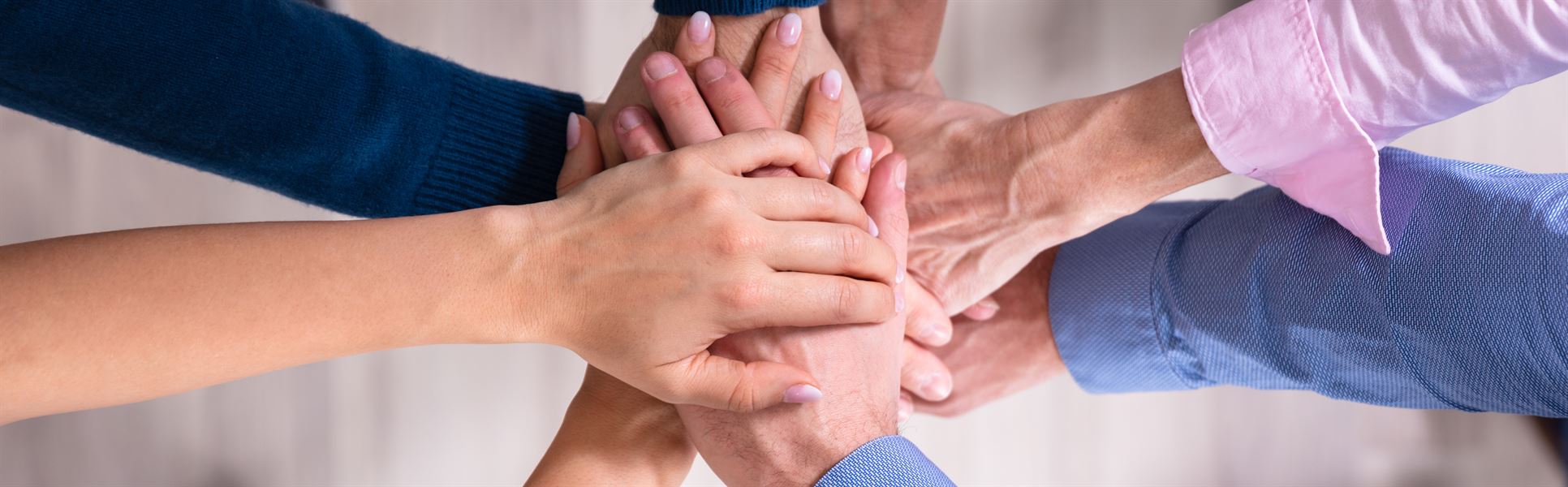 Businesspeople Stacking Hands Over Each Other