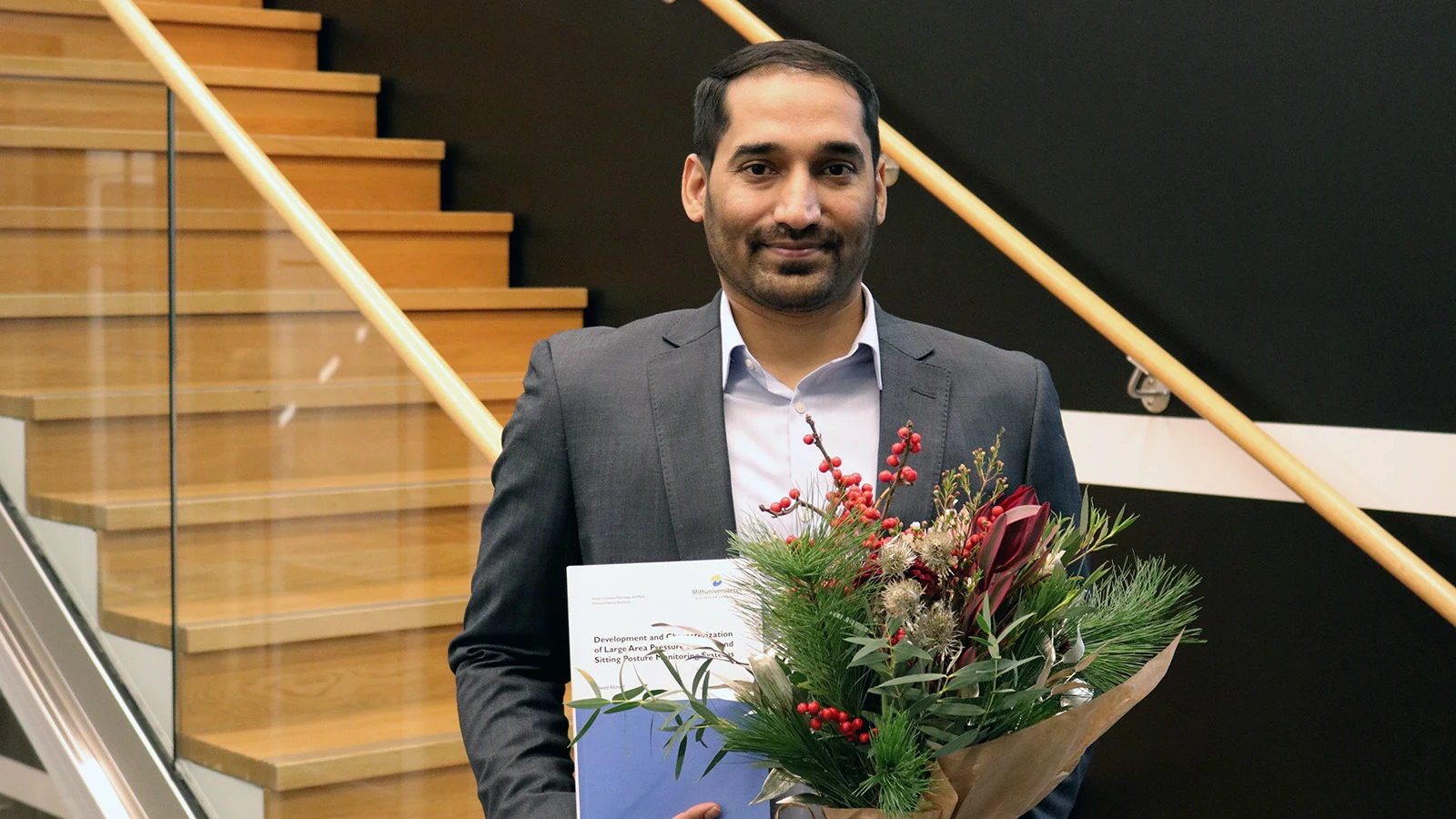 Jawad Ahmad with his dissertation after the dissertation.